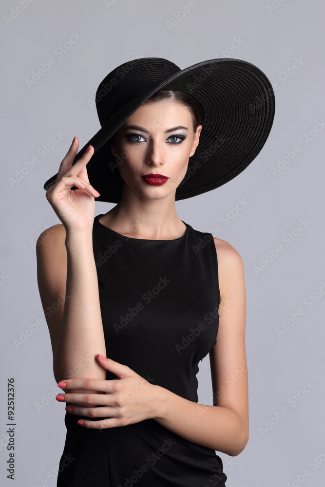 high fashion portrait of elegant woman in black hat. high fashion portrait of elegant woman in black hat.