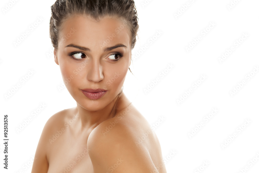young beautiful woman with bare shoulders posing on a white young beautiful woman with bare shoulders posing on a white