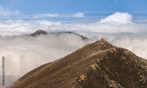 peaks of mountains above the clouds