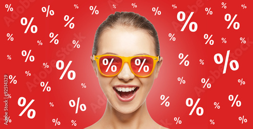 happy teenage girl in shades with percentage signs photo