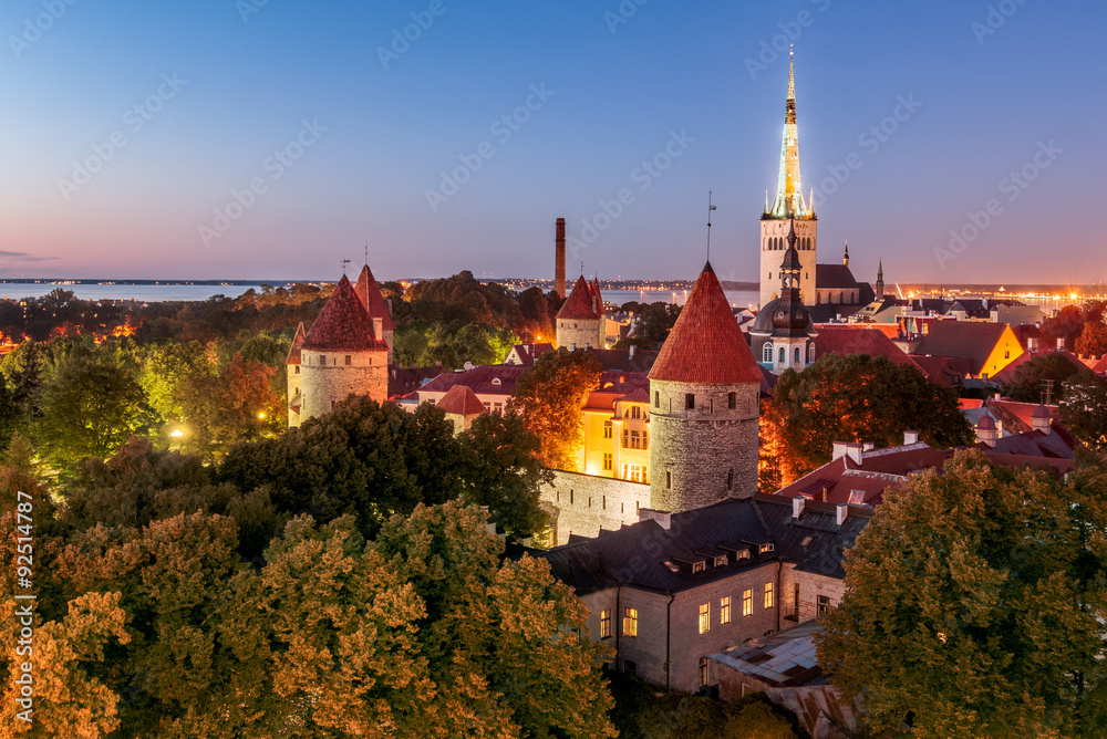 Old Tallinn, city walls, towers, churches and Bay of Tallinn by night