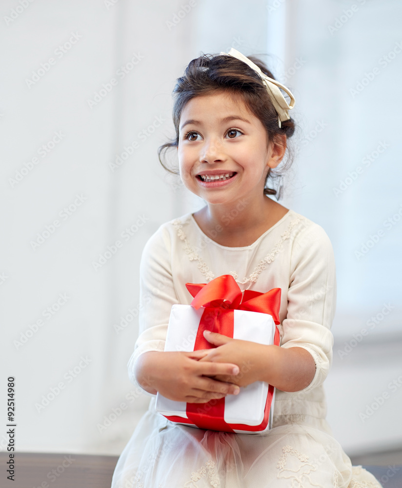 happy little girl with gift box at home