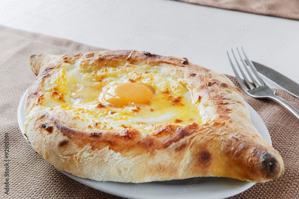 khachapuri with cheese and egg on a plate