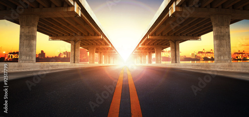 фотографія sun rising behind perspective on bridge ram construction and asp