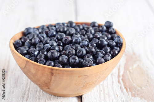 Wooden bowl with forest blueberry