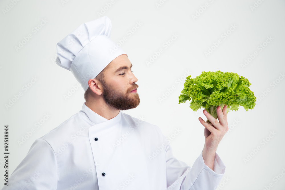Portrait of a handsome male chef cook holding salad Portrait of a handsome male chef cook holding salad
