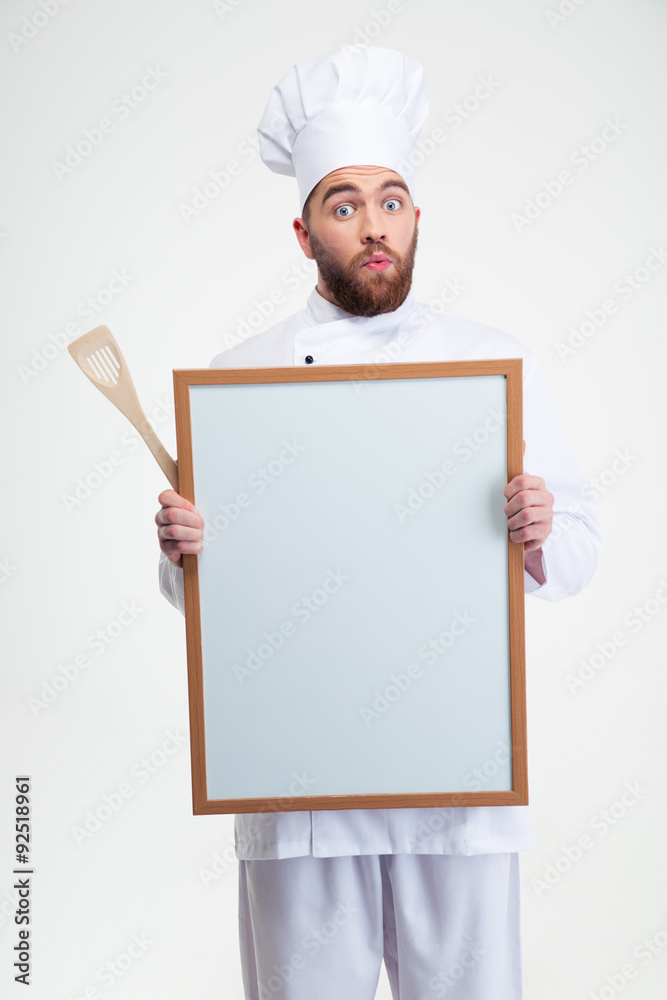 Funny male chef cook holding blank board Funny male chef cook holding blank board