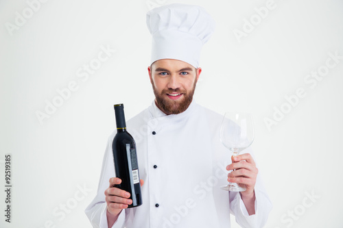 Male chef cook holding bottle of wine and wineglass i