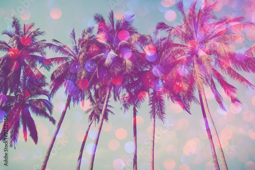 Palm trees on tropical beach with party glamour bokeh overlay, double exposure effect stylized