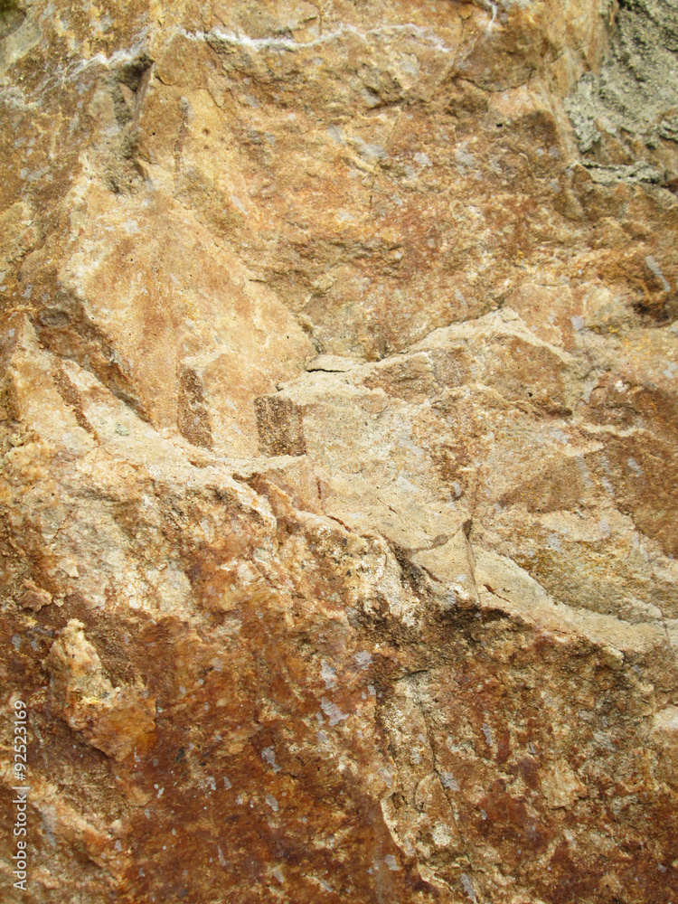Dark brown stone with cracks on the surface Dark brown stone with cracks on the surface
