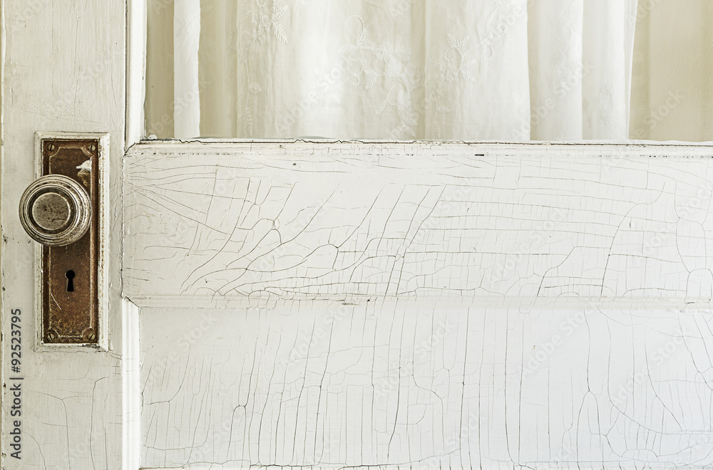 Obraz premium Old Exterior Door with Cracked White Paint and Rusty Old Hardwar