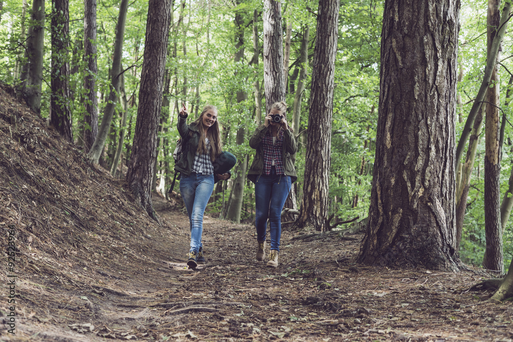 Twin sister walking on forest trail. Walking towards camera. Twin sister walking on forest trail. Walking towards camera.
