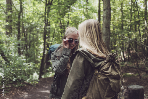 Twin sister having fun in forest.