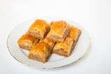 Sweet Baklava on plate isolated on white background.