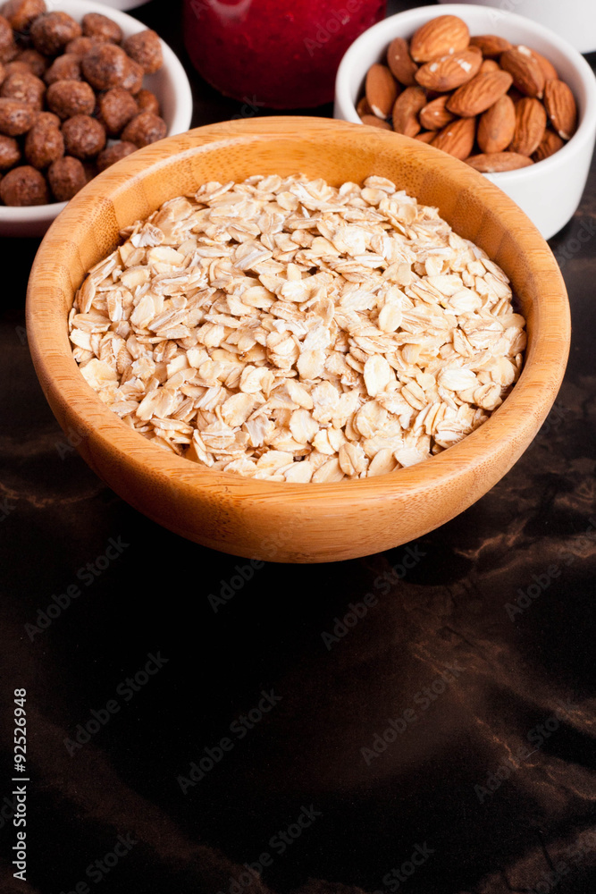 oat flakes, various ingredients for breakfast on black table oat flakes, various ingredients for breakfast on black table