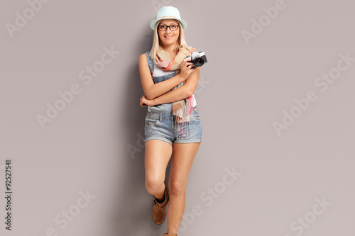 Blond female photographer holding a camera