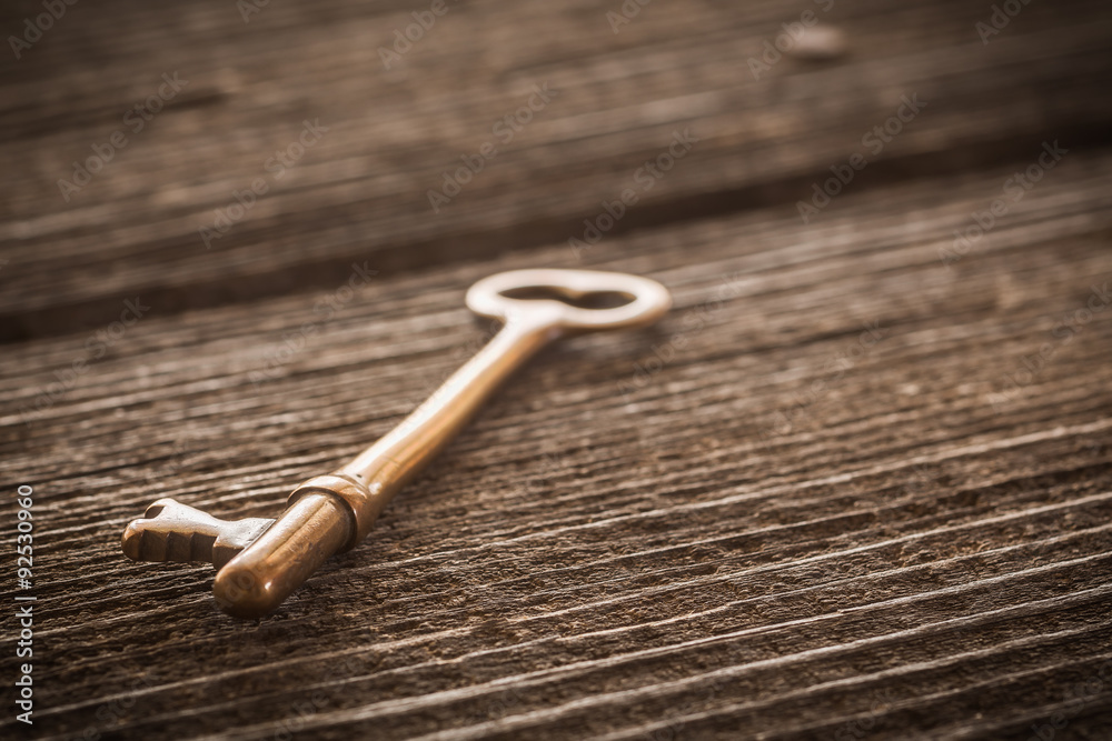Old Brass Skeleton Key on Dark Rustic Barnwood Old Brass Skeleton Key on Dark Rustic Barnwood