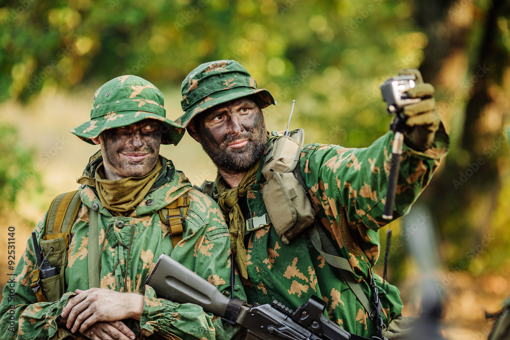 Selfie! soldiers taking pictures in the forest