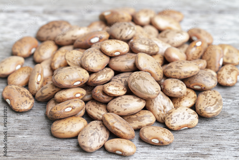 Pinto beans pile on wooden background. Pinto beans pile on wooden background.