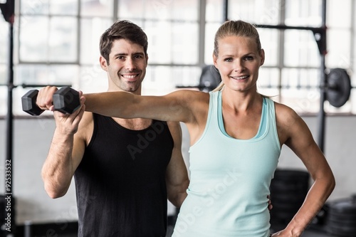  Male trainer helping woman with the dumbbells  © WavebreakmediaMicro