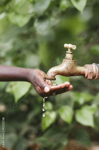 Water scarcity in the world symbol. African boy begging for water. In places like sub-Saharan Africa  time lost to gather water and suffering from water-borne diseases is limiting people s lives.