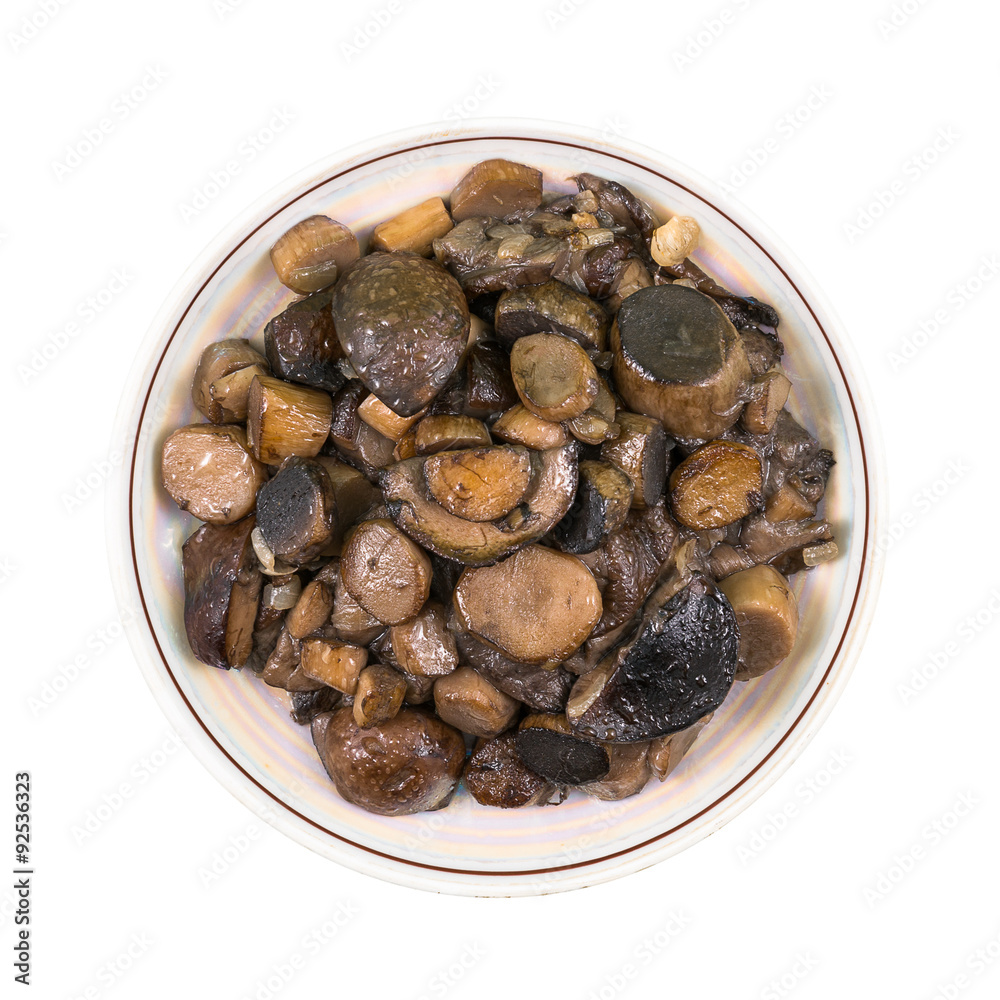Roasted wild mushrooms on a plate isolated on white Roasted wild mushrooms on a plate isolated on white