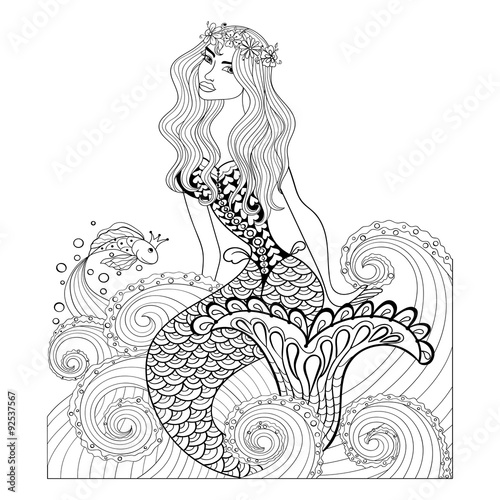 Fantastic mermaid in sea waves with a goldfish and wreath on the