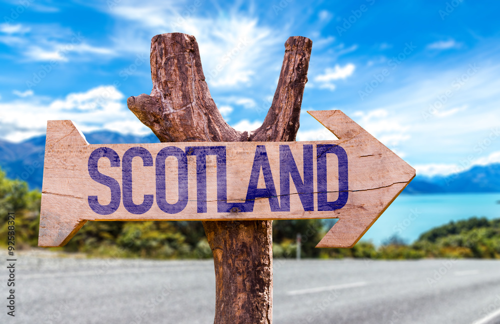 Scotland wooden sign with road background