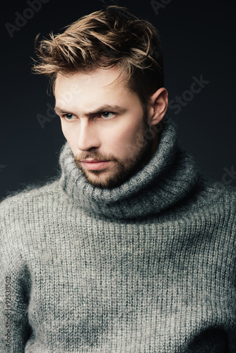 Portrait of an attractive young man with a beard in the studio