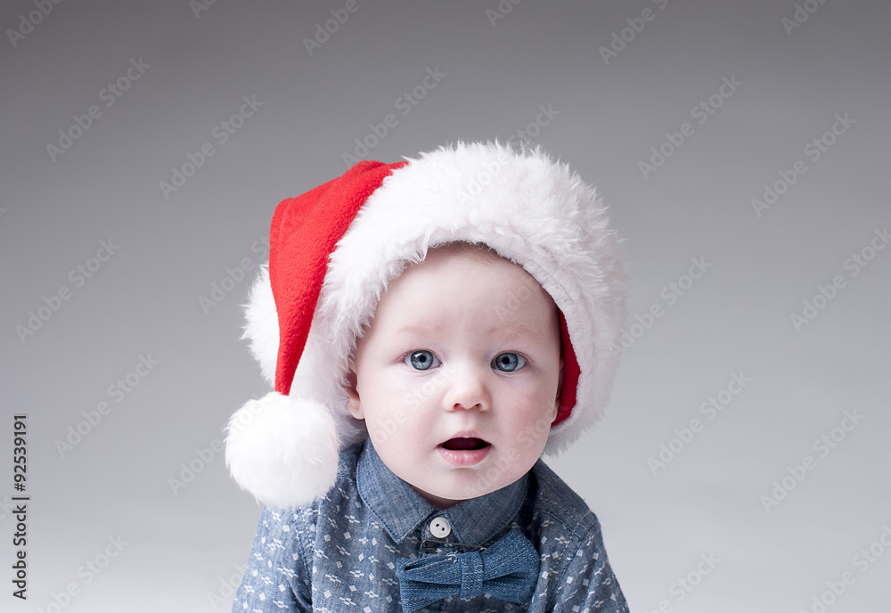 Portrait baby boy in santa hat cover gray background. Portrait baby boy in santa hat cover gray background.