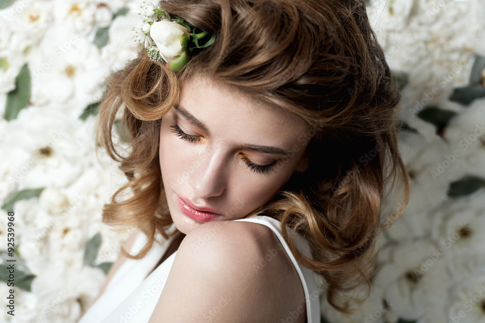 Portrait of a beautiful girl on a background of white flowers Portrait of a beautiful girl on a background of white flowers