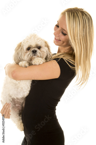 woman side smiel in black shirt looking at dog photo