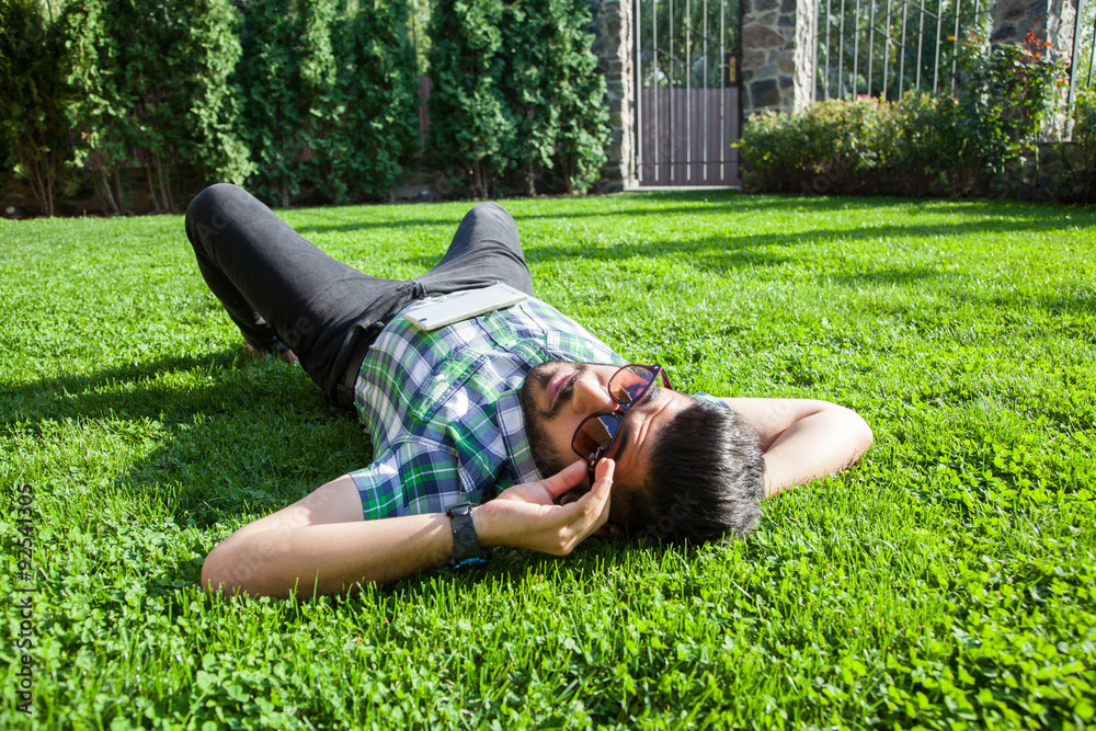 One fashion middle eastern man with beard, fashion hair style is resting on beautiful green grass day time.
young arab businessman 20-30 years, resting after hard work. smart phone, tablet. One fashion middle eastern man with beard, fashion hair style is resting on beautiful green grass day time.
young arab businessman 20-30 years, resting after hard work. smart phone, tablet.