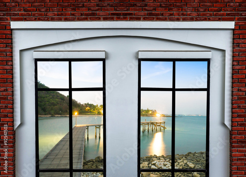white modern window on brick wall with dock on sea background