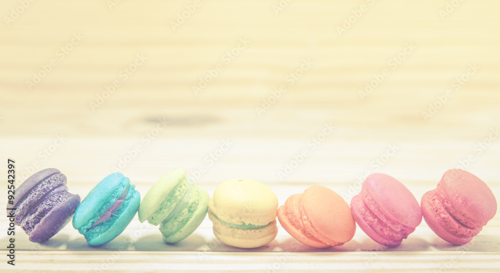 French macaroons on sack with wood background on filter color