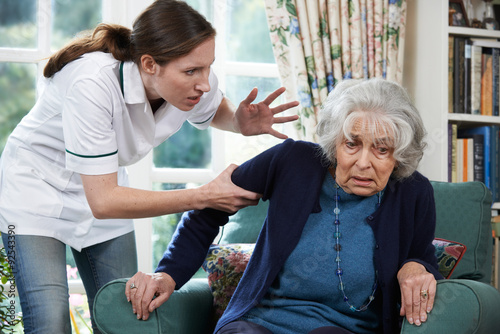 Care Worker Mistreating Senior Woman At Home photo