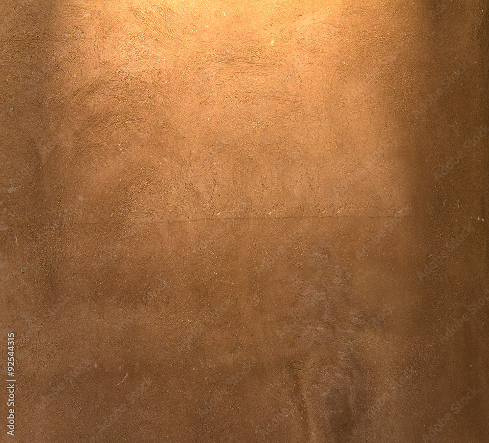 Naklejka premium Brązowy tynk pomalowany wzór tła z reflektorem i miejsce na swój projekt lub tekst