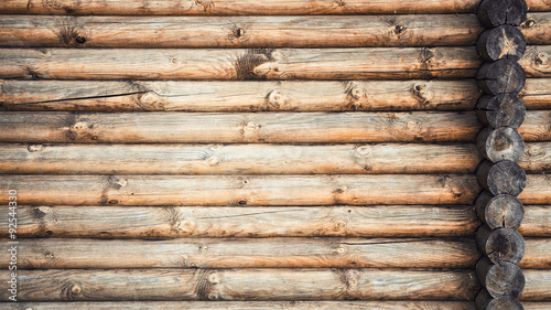Wooden logs wall and ends of logs