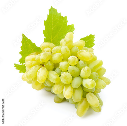 Ripe grapes with leaves close up on white background .