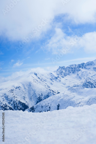 Beautiful snow-capped mountains against the blue sky © V&P Photo Studio