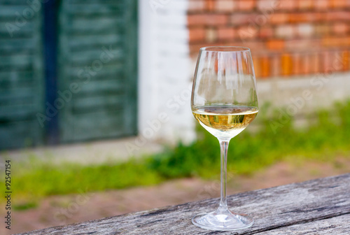 Glass of white wine on wooden table