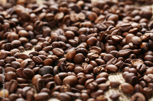 Roasted coffee beans on a sack, close up