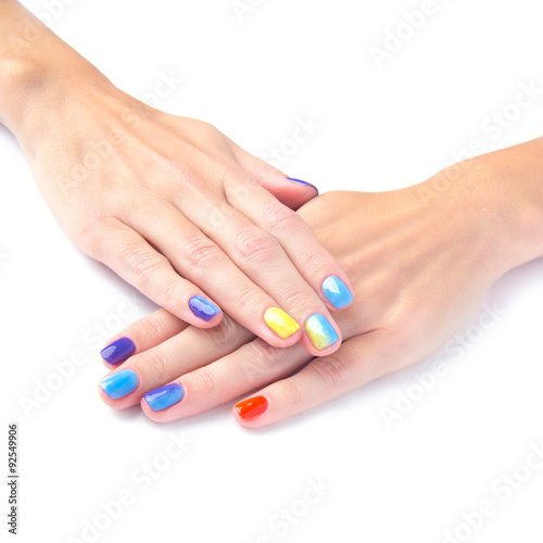 Bright manicure hands on white background
