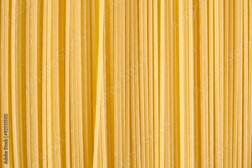 Background made of raw pasta stacked vertically