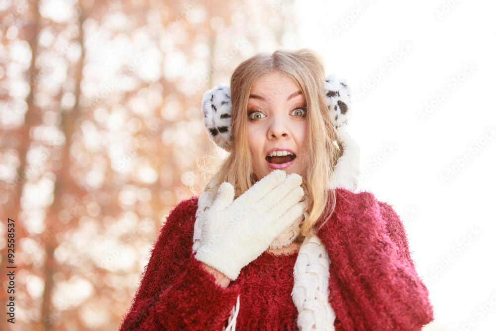Portrait of pretty smiling woman in earmuffs. Portrait of pretty smiling woman in earmuffs.