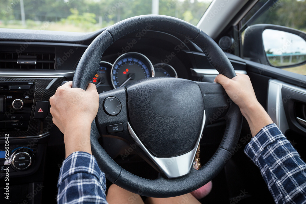 Close-up Of Woman's Hand Holding Steering Wheel for car driver