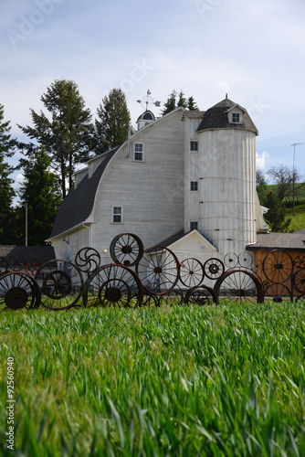 a barn with wheel fence photo