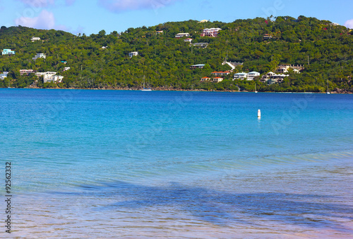 Caribbean Sea in the morning with yachts and palm long shadows. Palm shadow in blue waters of Magens Bay on Thomas Island, US VI. photo
