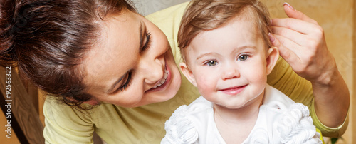 Bilde på lerret Mother and baby playing and smiling. Happy family.Home interior.