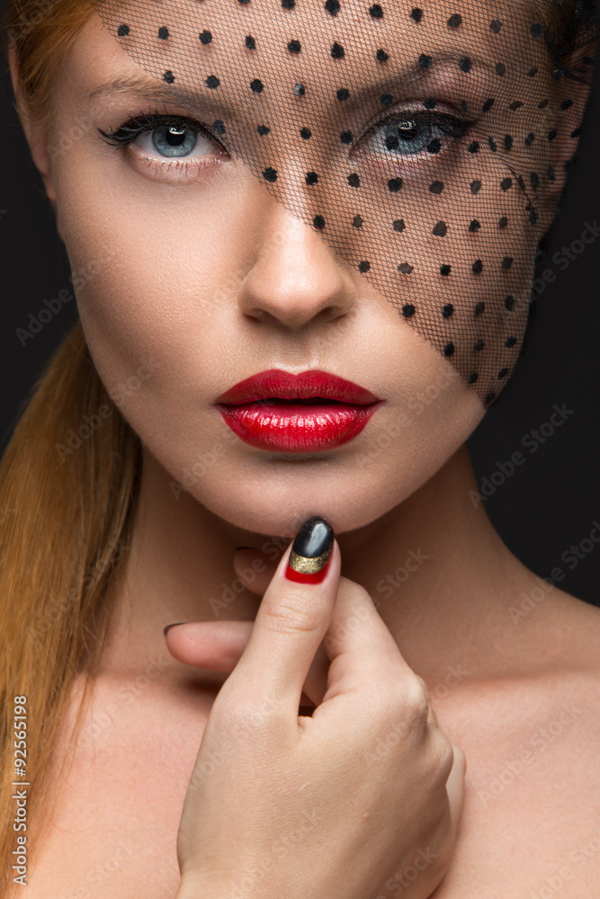 Beautiful girl with a veil, evening makeup, black and red nails Beautiful girl with a veil, evening makeup, black and red nails
